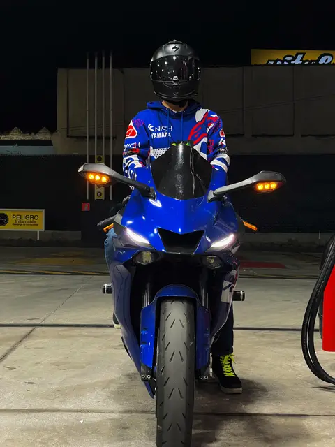 Facing the camera on the bike at night, its headlights on
