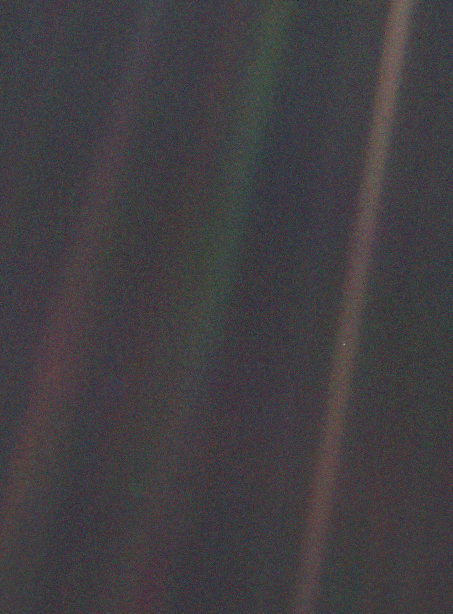 Bands of scattered light over the black of space; in one of them, a tiny dot: the Earth